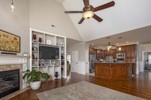9704 Starry Way, Soddy Daisy, TN 37379 - living area featuring high vaulted ceiling, ceiling fan, dark wood-type flooring, and a tiled fireplace