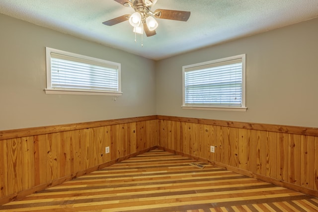 252 Valley View Dr, Dunlap, TN 37327 - spare room with wood finished floors, a wainscoted wall, wooden walls, and ceiling fan