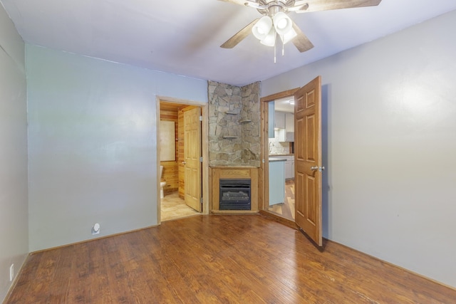 252 Valley View Dr, Dunlap, TN 37327 - unfurnished living room with a glass covered fireplace, wood finished floors, a ceiling fan, and heating unit