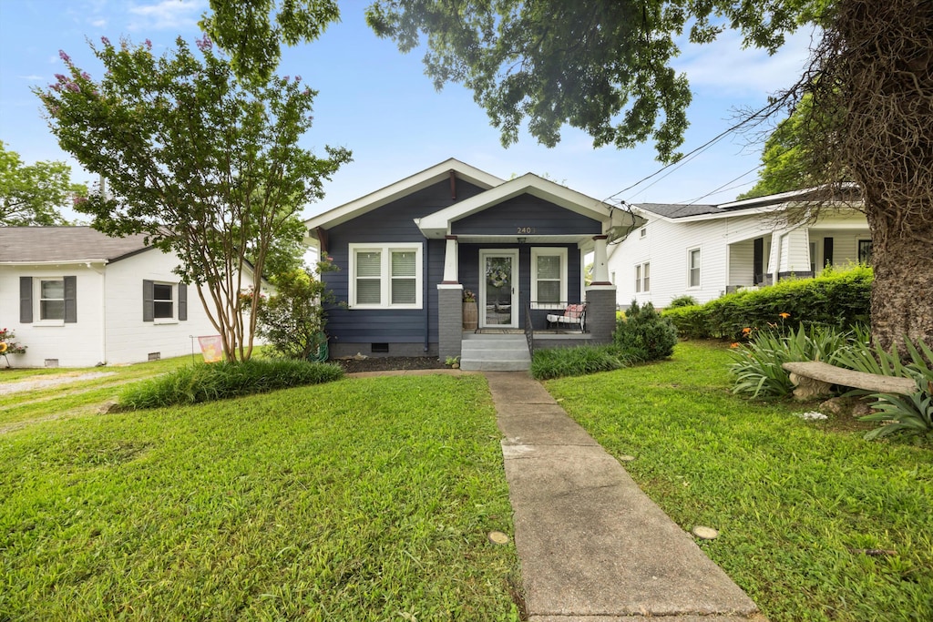 2403 Ivy St, Chattanooga, TN 37404 - view of front of home featuring covered porch, a front lawn, and crawl space