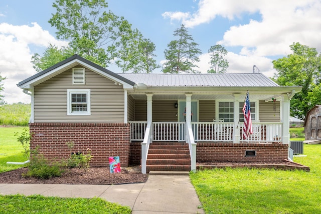 300 Bronco Rd, Lafayette, GA 30728 - bungalow-style house with covered porch, a front lawn, brick siding, metal roof, and central AC