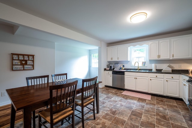 300 Bronco Rd, Lafayette, GA 30728 - kitchen with dishwasher, a sink, dark countertops, white cabinetry, and dark stone finish floors