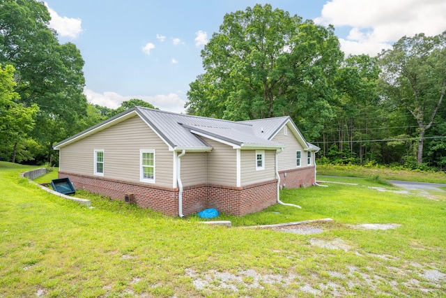 300 Bronco Rd, Lafayette, GA 30728 - view of home's exterior with brick siding, a lawn, and metal roof