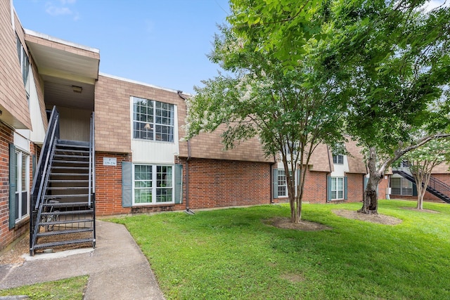 900 Mountain Creek Rd Unit P234, Chattanooga, TN 37405 - view of front facade with brick siding, stairway, and a front lawn