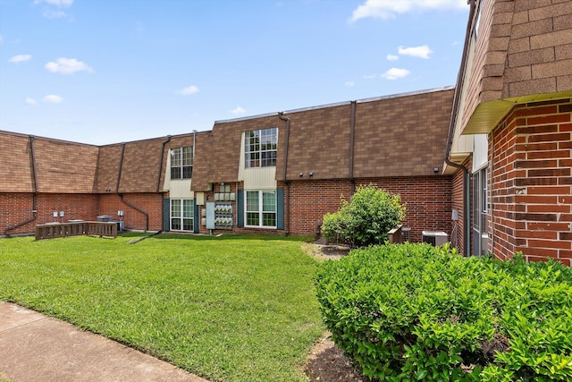900 Mountain Creek Rd Unit P234, Chattanooga, TN 37405 - rear view of house featuring roof with shingles, mansard roof, brick siding, a lawn, and central AC unit