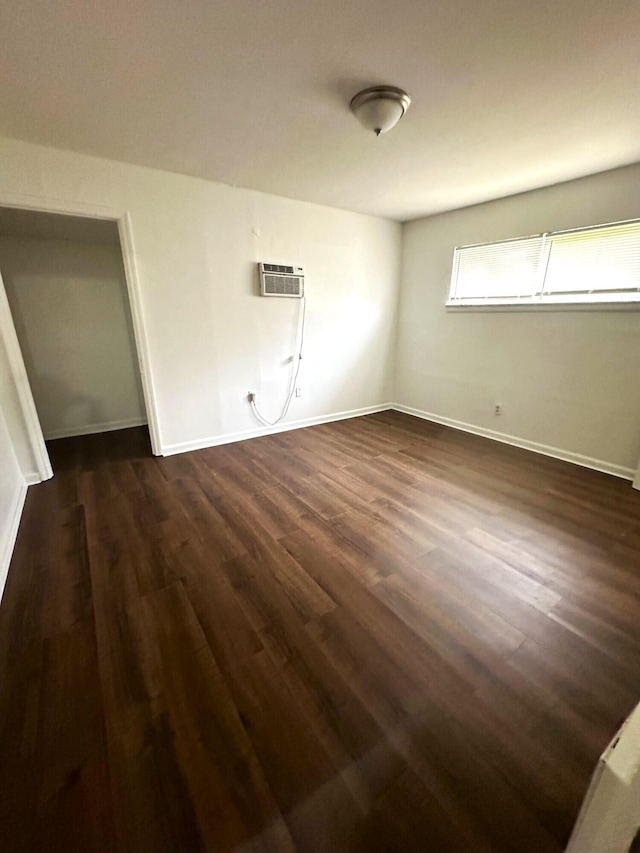 2011 Milne St, Chattanooga, TN 37406 - unfurnished bedroom with dark wood-style floors and an AC wall unit