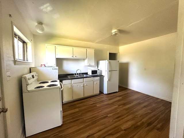 2011 Milne St, Chattanooga, TN 37406 - kitchen with white appliances, dark countertops, dark wood-style flooring, and white cabinetry