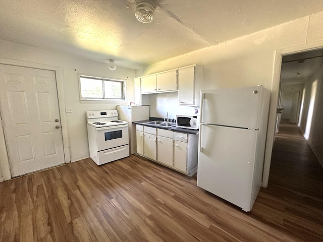 2011 Milne St, Chattanooga, TN 37406 - kitchen with white appliances, dark wood finished floors, white cabinets, and dark countertops