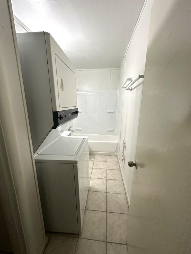 2011 Milne St, Chattanooga, TN 37406 - laundry area with stacked washer / drying machine and light tile patterned floors