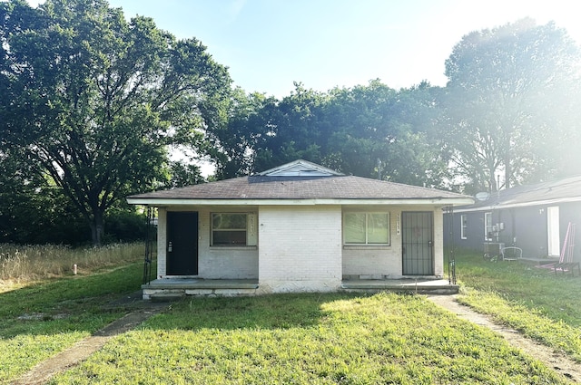 2011 Milne St, Chattanooga, TN 37406 - view of front of house with a front yard, brick siding, and roof with shingles