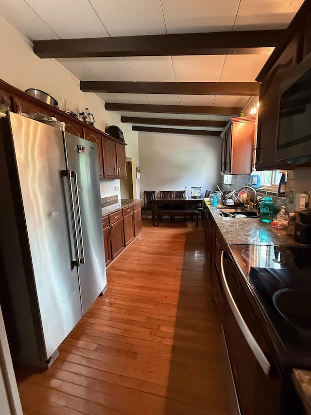 4509 Dumac Rd, Chattanooga, TN 37416 - kitchen with stainless steel appliances, light wood-style flooring, beamed ceiling, decorative backsplash, and dark brown cabinets