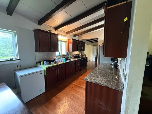 4509 Dumac Rd, Chattanooga, TN 37416 - kitchen featuring stainless steel electric range, backsplash, light wood-style floors, dark brown cabinetry, and fridge