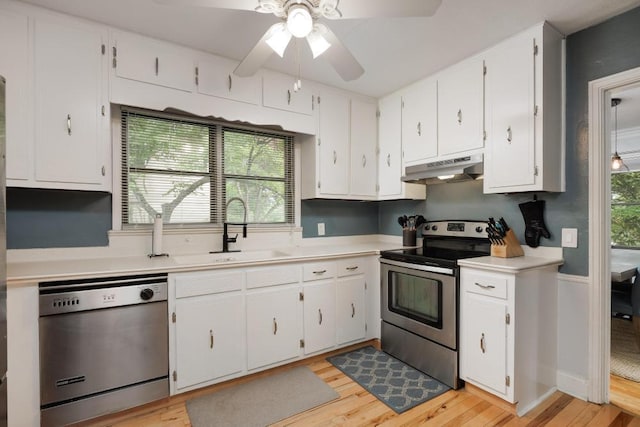 3606 Gleason Dr, Chattanooga, TN 37412 - kitchen with appliances with stainless steel finishes, under cabinet range hood, light wood-style flooring, and light countertops