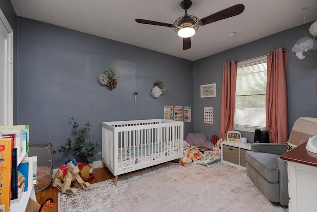 3606 Gleason Dr, Chattanooga, TN 37412 - bedroom with a crib, wood finished floors, and a ceiling fan