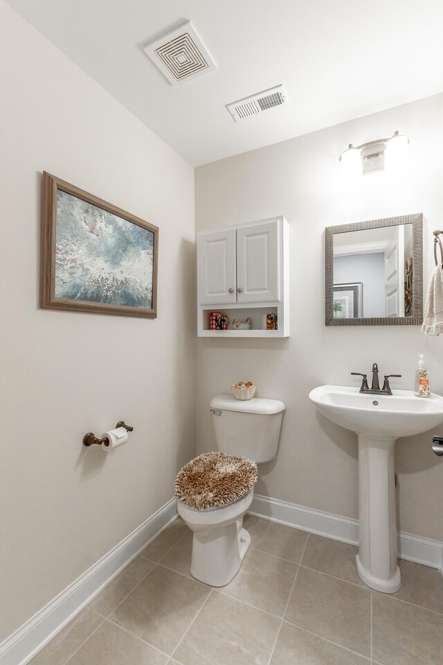 9058 Knolling Loop, Ooltewah, TN 37363 - bathroom with tile patterned floors, toilet, baseboards, and a sink