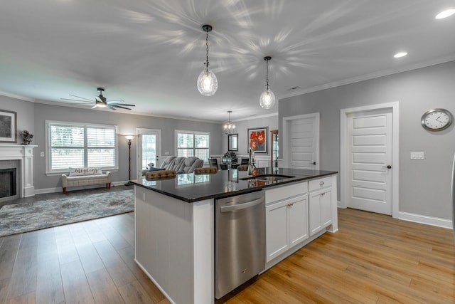 9058 Knolling Loop, Ooltewah, TN 37363 - kitchen with dishwasher, a sink, open floor plan, dark countertops, and light wood finished floors