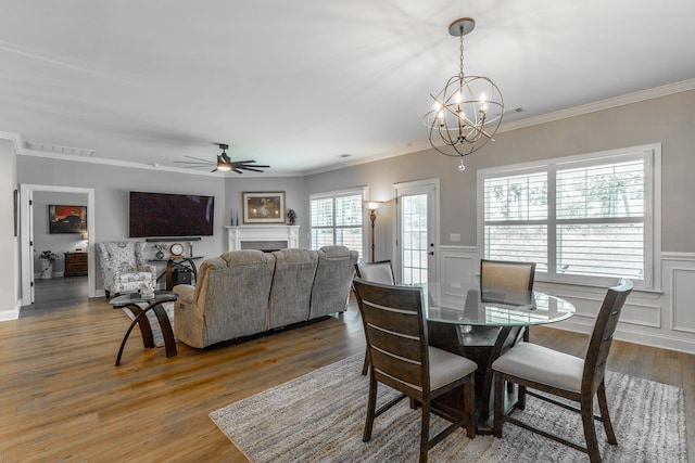 9058 Knolling Loop, Ooltewah, TN 37363 - dining room featuring wood finished floors, crown molding, a chandelier, a wainscoted wall, and ceiling fan