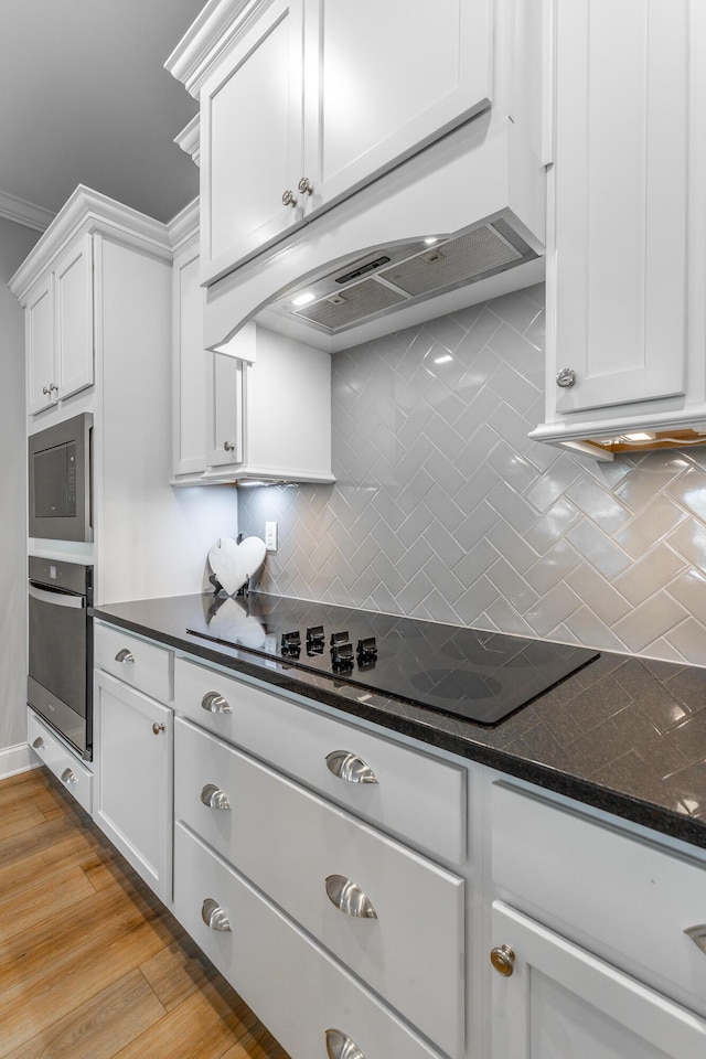 9058 Knolling Loop, Ooltewah, TN 37363 - kitchen featuring appliances with stainless steel finishes, tasteful backsplash, white cabinets, and light wood-type flooring
