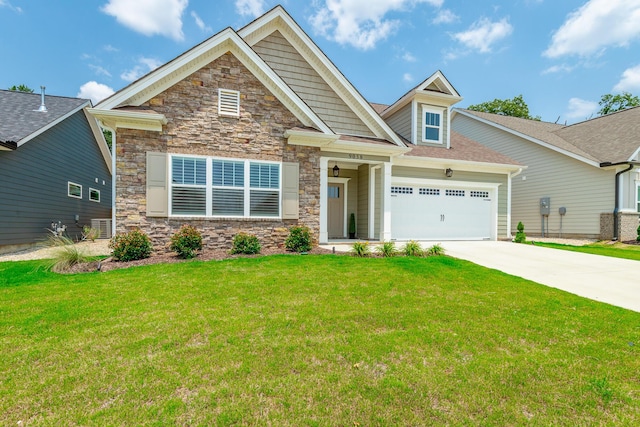 9058 Knolling Loop, Ooltewah, TN 37363 - craftsman-style home featuring concrete driveway, an attached garage, a front yard, and stone siding