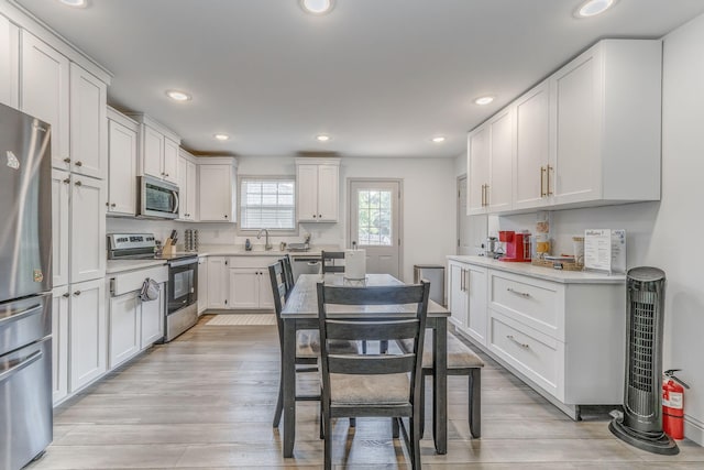 2091 Hummingbird Dr, Dalton, GA 30721 - kitchen with appliances with stainless steel finishes, white cabinets, recessed lighting, and light countertops