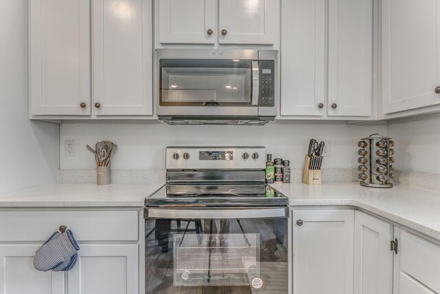 2091 Hummingbird Dr, Dalton, GA 30721 - kitchen featuring stainless steel appliances and white cabinetry