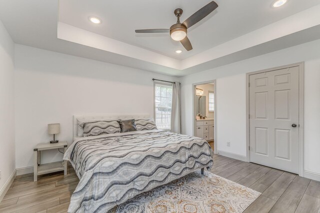 2091 Hummingbird Dr, Dalton, GA 30721 - bedroom featuring light wood-style floors, a raised ceiling, recessed lighting, ensuite bath, and ceiling fan