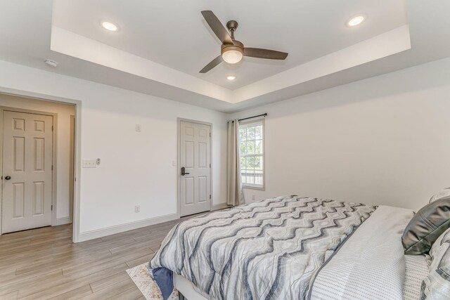 2091 Hummingbird Dr, Dalton, GA 30721 - bedroom featuring a tray ceiling, light wood-type flooring, recessed lighting, and a ceiling fan