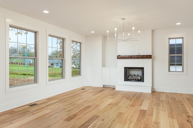 8654 Woodbury Acre Ct, Harrison, TN 37341 - unfurnished living room with healthy amount of natural light, light wood-style floors, a chandelier, and recessed lighting