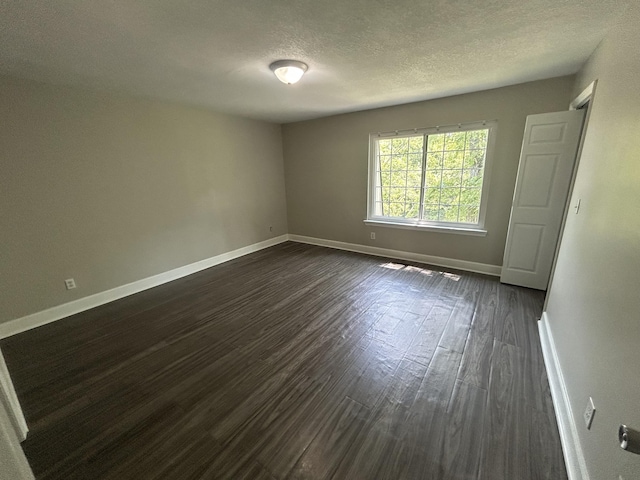 3955 Teakwood Dr, Chattanooga, TN 37416 - spare room with baseboards, a textured ceiling, and dark wood-type flooring