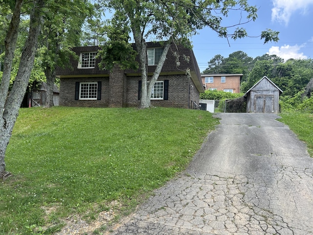 3955 Teakwood Dr, Chattanooga, TN 37416 - view of front of property with brick siding, a garage, asphalt driveway, a storage shed, and a shingled roof