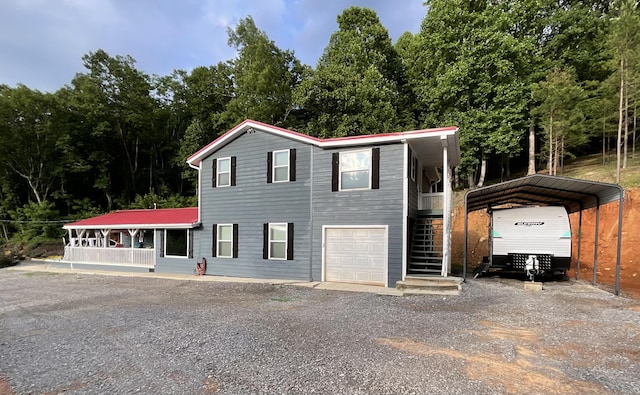 690 Ditch Gap Rd, Whitwell, TN 37397 - view of front facade with stairs, driveway, a detached carport, and a garage