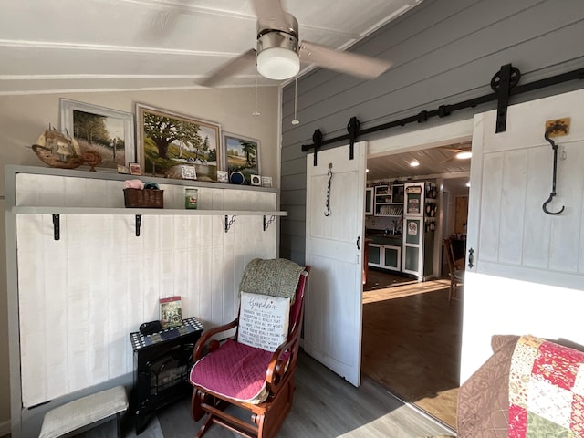 690 Ditch Gap Rd, Whitwell, TN 37397 - mudroom featuring a barn door, wood finished floors, vaulted ceiling, a ceiling fan, and wood walls
