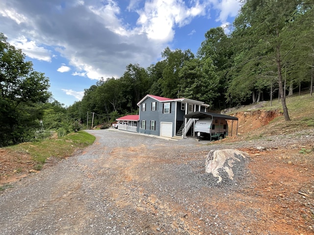690 Ditch Gap Rd, Whitwell, TN 37397 - view of front facade with dirt driveway, an attached garage, and stairs