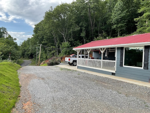 690 Ditch Gap Rd, Whitwell, TN 37397 - view of front of house featuring covered porch, metal roof, and a view of trees