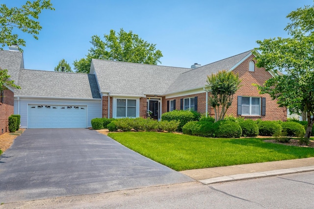 1099 Constitution Dr, Chattanooga, TN 37405 - view of front of property featuring brick siding, a garage, asphalt driveway, and a front lawn