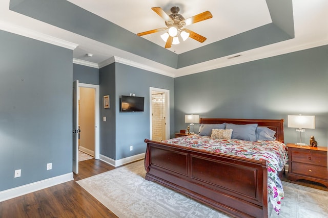 2311 Waterhaven Dr, Chattanooga, TN 37406 - bedroom featuring wood finished floors, crown molding, a tray ceiling, a ceiling fan, and ensuite bathroom