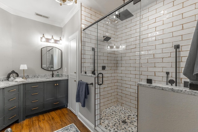 2311 Waterhaven Dr, Chattanooga, TN 37406 - full bathroom with wood finished floors, a tile shower, ornamental molding, and vanity