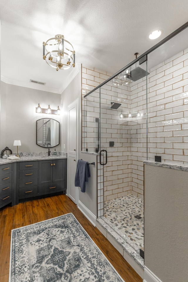 2311 Waterhaven Dr, Chattanooga, TN 37406 - full bathroom featuring a shower stall, vanity, a chandelier, and wood finished floors