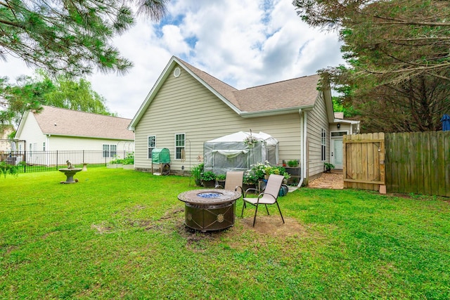 2311 Waterhaven Dr, Chattanooga, TN 37406 - rear view of house with an outdoor fire pit, roof with shingles, and a fenced backyard