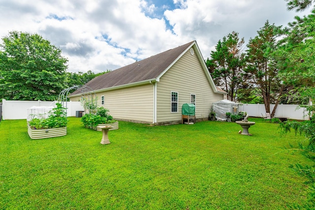 2311 Waterhaven Dr, Chattanooga, TN 37406 - view of side of home with a garden, a fenced backyard, and a shingled roof