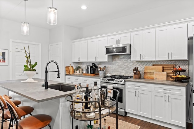 812 Merriam St, Chattanooga, TN 37405 - kitchen featuring stainless steel appliances, decorative backsplash, white cabinetry, a breakfast bar, and recessed lighting