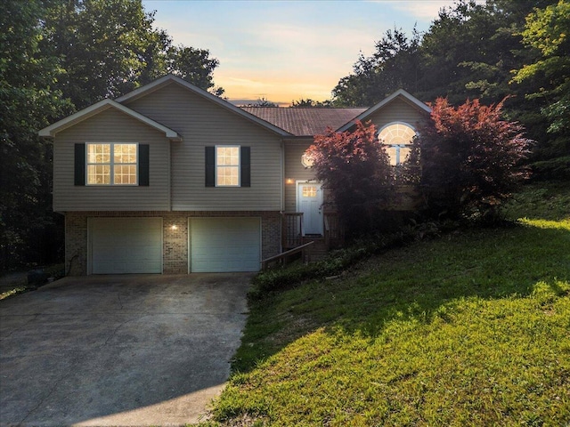 487 Ridge Rd, Lafayette, GA 30728 - view of front of home featuring an attached garage, brick siding, concrete driveway, and a lawn