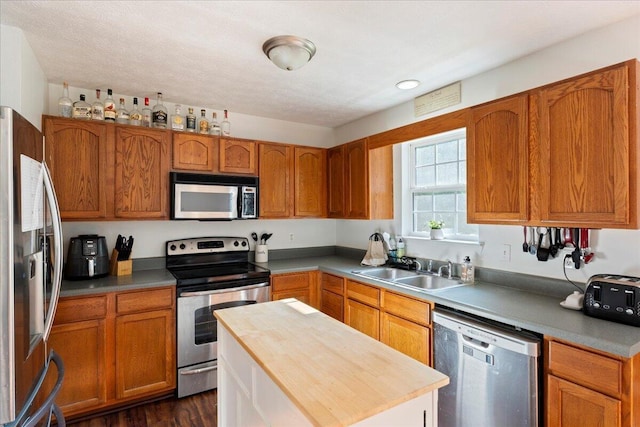 487 Ridge Rd, Lafayette, GA 30728 - kitchen featuring stainless steel appliances, a sink, butcher block countertops, and brown cabinets