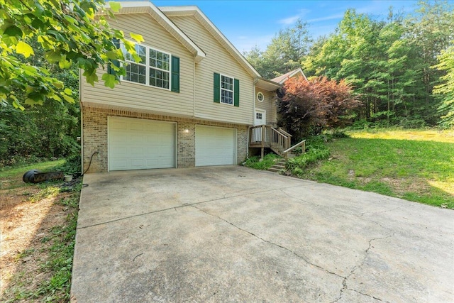 487 Ridge Rd, Lafayette, GA 30728 - view of side of home featuring brick siding, an attached garage, driveway, and a lawn