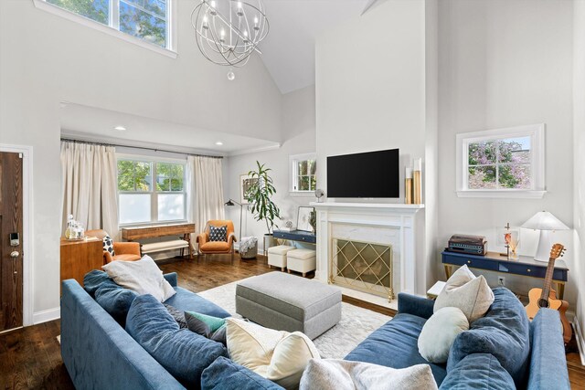 410 Stringer St, Chattanooga, TN 37405 - living area featuring high vaulted ceiling, plenty of natural light, wood finished floors, a chandelier, and a fireplace