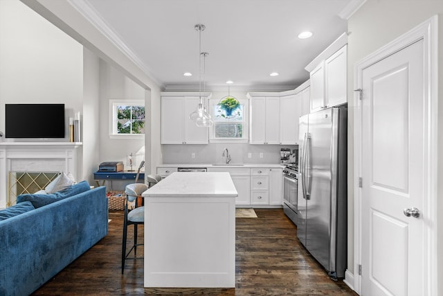 410 Stringer St, Chattanooga, TN 37405 - kitchen with stainless steel appliances, a sink, open floor plan, ornamental molding, and a center island