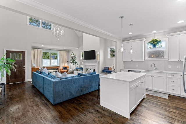 410 Stringer St, Chattanooga, TN 37405 - living room featuring ornamental molding, dark wood-style flooring, recessed lighting, a chandelier, and a fireplace
