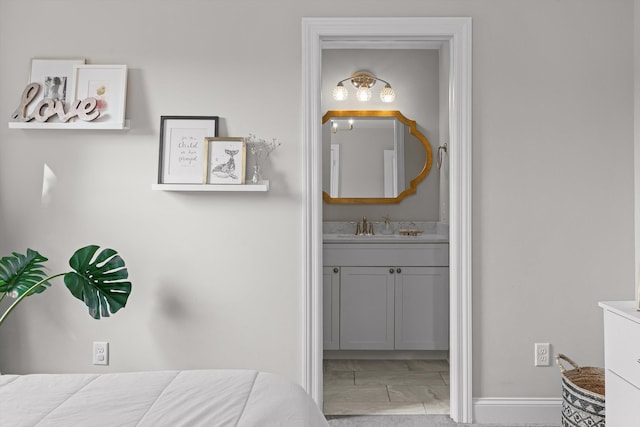 410 Stringer St, Chattanooga, TN 37405 - bedroom featuring light marble finish floors, ensuite bath, baseboards, and a sink
