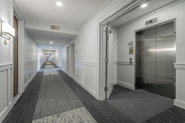 200 Manufacturers Rd Apt 507, Chattanooga, TN 37405 - hallway featuring elevator, a wainscoted wall, dark colored carpet, recessed lighting, and a decorative wall
