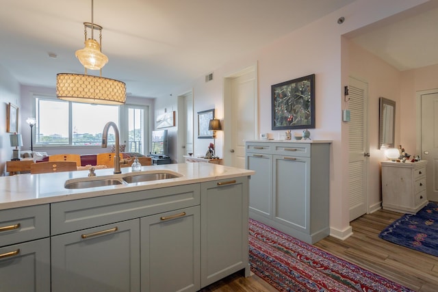 200 Manufacturers Rd Apt 507, Chattanooga, TN 37405 - kitchen featuring gray cabinetry, dark wood-style flooring, and hanging light fixtures